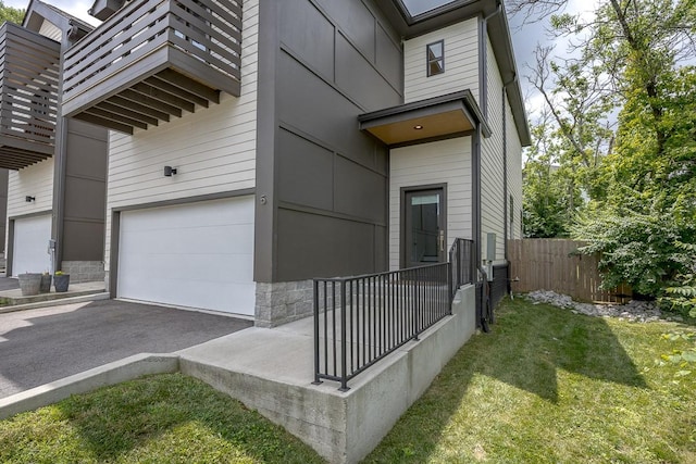 206 Ben Allen Rd Unit 5, Nashville, TN 37207 - view of side of property with a garage, a balcony, driveway, and stone siding