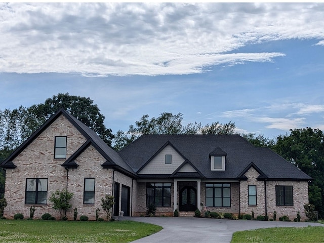 7182 Eagle Ridge Ln, Bowling Green, KY 42103 - view of front of home with french doors, driveway, a garage, and brick siding