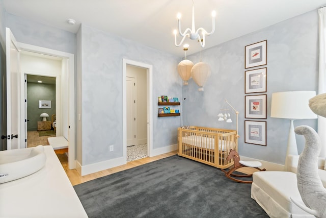 1209 Noelton Ave, Nashville, TN 37215 - bedroom featuring a chandelier, wood finished floors, and a nursery area