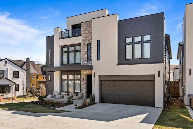 1209 Noelton Ave, Nashville, TN 37215 - modern home with driveway, stone siding, stucco siding, a garage, and a balcony