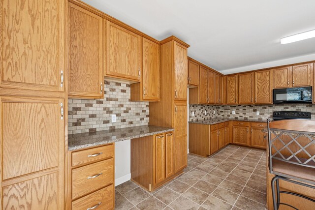 821 Alex Way, Mount Juliet, TN 37122 - kitchen with black appliances, decorative backsplash, light tile patterned floors, brown cabinets, and light stone counters