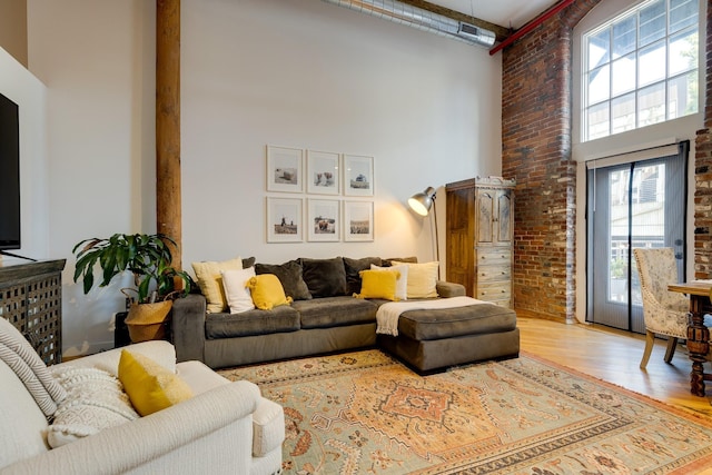 1350 Rosa L Parks Blvd Unit 365, Nashville, TN 37208 - living room with a high ceiling, wood finished floors, and brick wall