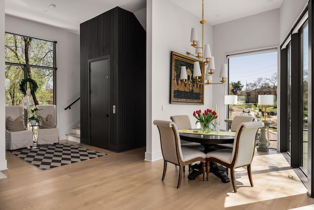 108 46th Ave N, Nashville, TN 37209 - dining space featuring light wood-style floors, a chandelier, and stairs