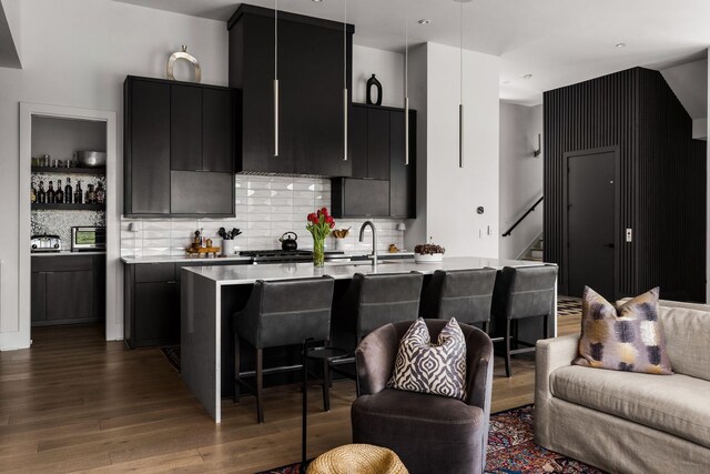 108 46th Ave N, Nashville, TN 37209 - kitchen featuring dark cabinetry, wood finished floors, open floor plan, and light countertops