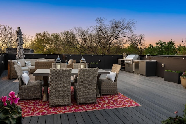 108 46th Ave N, Nashville, TN 37209 - deck at dusk with an outdoor kitchen, outdoor dining area, and an outdoor living space