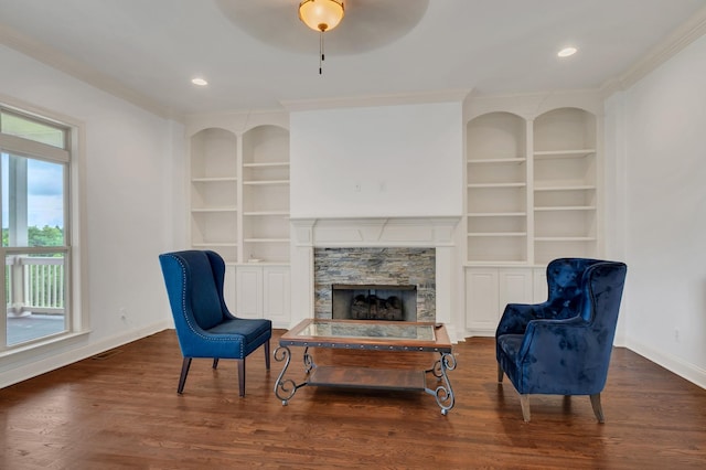 438 Truman Rd, Franklin, TN 37064 - sitting room with built in shelves, ornamental molding, a fireplace, wood finished floors, and ceiling fan