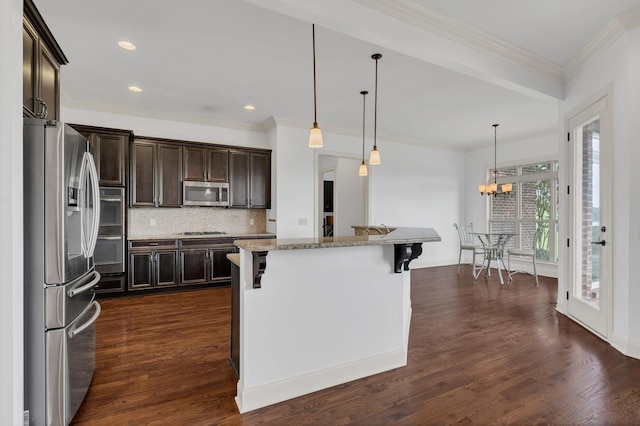 438 Truman Rd, Franklin, TN 37064 - kitchen featuring stainless steel appliances, a breakfast bar, dark brown cabinetry, tasteful backsplash, and crown molding