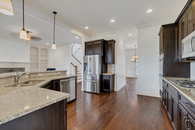 438 Truman Rd, Franklin, TN 37064 - kitchen with stainless steel appliances, light stone counters, dark brown cabinets, tasteful backsplash, and ornamental molding