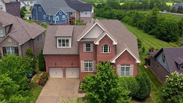 438 Truman Rd, Franklin, TN 37064 - traditional home with brick siding, a garage, a residential view, a shingled roof, and driveway