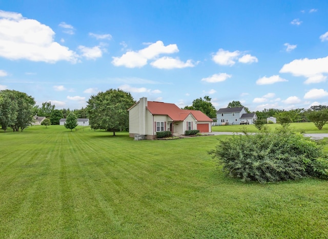 110 Sandis Ln, Palmyra, TN 37142 - view of grassy yard featuring a garage and driveway
