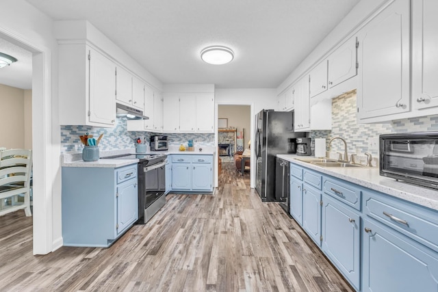 110 Sandis Ln, Palmyra, TN 37142 - kitchen featuring stainless steel appliances, under cabinet range hood, blue cabinetry, and light countertops