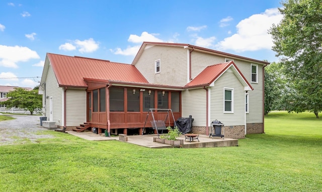 110 Sandis Ln, Palmyra, TN 37142 - rear view of property featuring a patio area, a sunroom, a yard, a metal roof, and crawl space