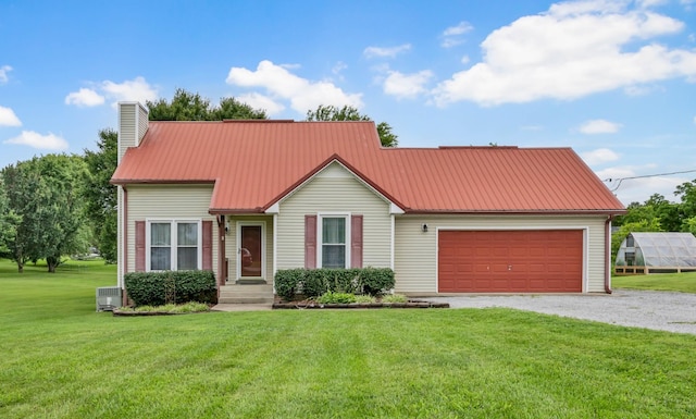 110 Sandis Ln, Palmyra, TN 37142 - view of front of home with a chimney, driveway, an attached garage, a front lawn, and a metal roof