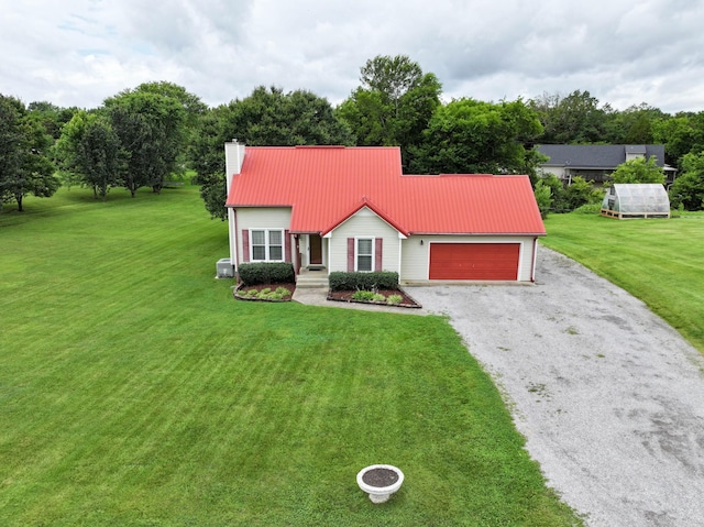 110 Sandis Ln, Palmyra, TN 37142 - view of front of house with gravel driveway, a garage, a front yard, a chimney, and a metal roof