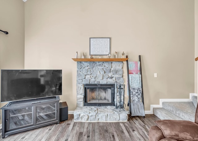 110 Sandis Ln, Palmyra, TN 37142 - living area featuring wood finished floors, stairway, and a fireplace