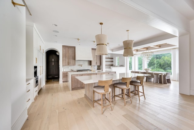1713 Reflection Ln, Brentwood, TN 37027 - kitchen with a large island, light wood finished floors, light countertops, tasteful backsplash, and recessed lighting