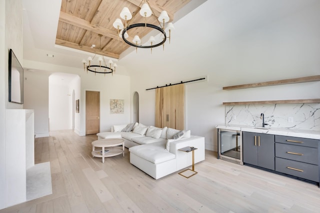 1713 Reflection Ln, Brentwood, TN 37027 - living room featuring a wooden ceiling with exposed beams, arched walkways, a chandelier, light wood-style floors, and wine cooler