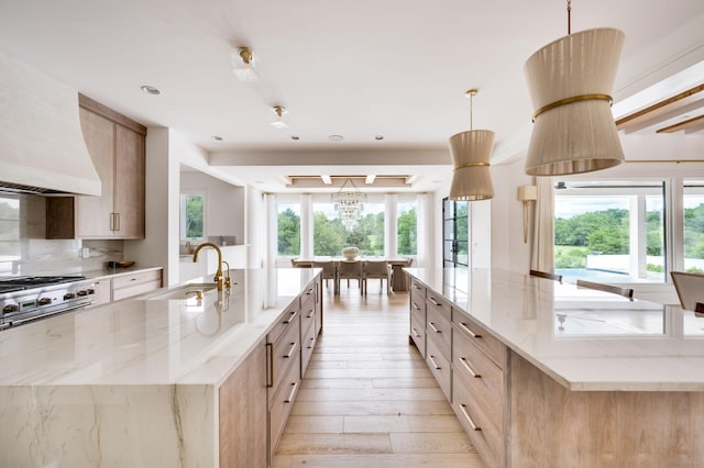 1713 Reflection Ln, Brentwood, TN 37027 - kitchen with a large island, premium range hood, light wood-style flooring, light stone counters, and light brown cabinets