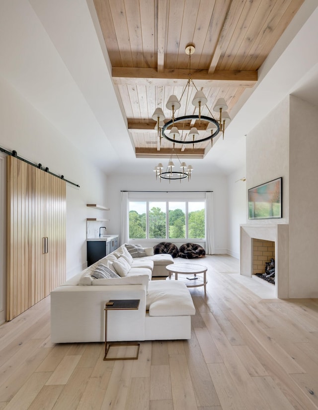 1713 Reflection Ln, Brentwood, TN 37027 - living area with a wood ceiling with exposed beams, a chandelier, light wood finished floors, a tray ceiling, and a barn door