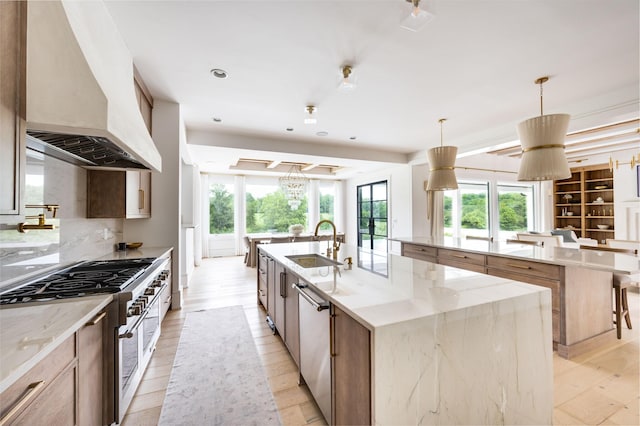 1713 Reflection Ln, Brentwood, TN 37027 - kitchen with a large island with sink, appliances with stainless steel finishes, custom exhaust hood, light stone counters, and recessed lighting