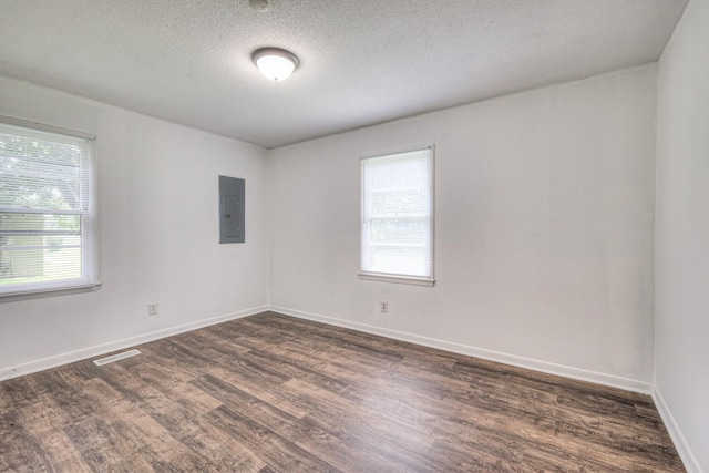 131 Clauson Dr, Columbia, TN 38401 - spare room featuring electric panel, healthy amount of natural light, dark wood-style flooring, and a textured ceiling