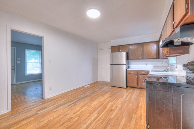 131 Clauson Dr, Columbia, TN 38401 - kitchen featuring freestanding refrigerator, black / electric stove, under cabinet range hood, and light wood-style flooring