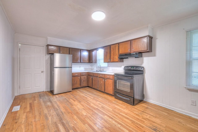 131 Clauson Dr, Columbia, TN 38401 - kitchen featuring black electric range, freestanding refrigerator, light wood-style floors, under cabinet range hood, and light countertops