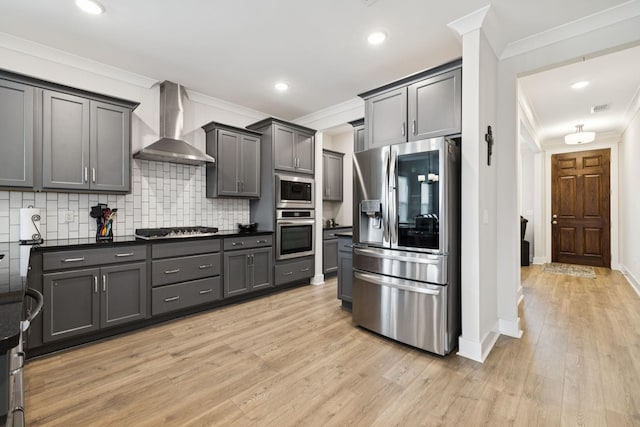 3737 Felipe Way, Murfreesboro, TN 37129 - kitchen with appliances with stainless steel finishes, wall chimney exhaust hood, ornamental molding, tasteful backsplash, and light wood-type flooring