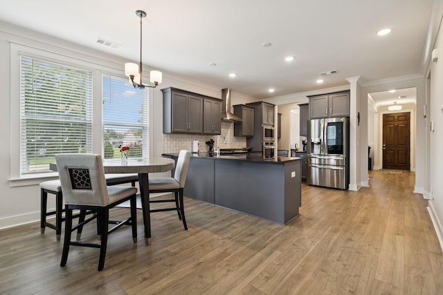 3737 Felipe Way, Murfreesboro, TN 37129 - kitchen with appliances with stainless steel finishes, wall chimney range hood, dark countertops, a peninsula, and crown molding