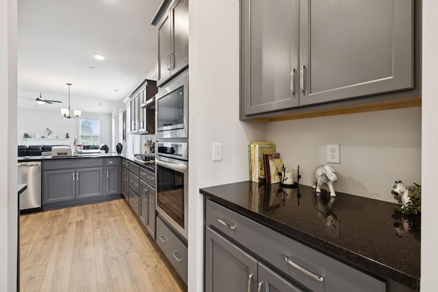 3737 Felipe Way, Murfreesboro, TN 37129 - kitchen with stainless steel appliances, gray cabinets, light wood-style flooring, hanging light fixtures, and ceiling fan
