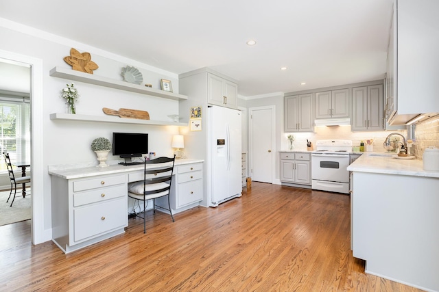 1028 Ridgecrest Dr, Franklin, TN 37069 - kitchen with white appliances, open shelves, built in study area, under cabinet range hood, and light wood-style floors