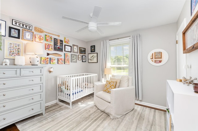 1028 Ridgecrest Dr, Franklin, TN 37069 - bedroom with light wood-type flooring, a crib, and a ceiling fan