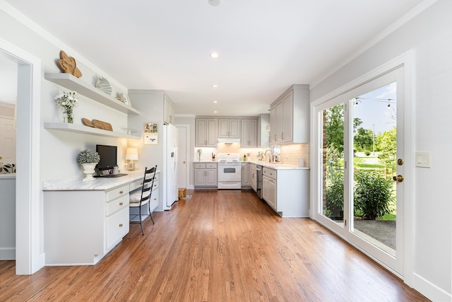 1028 Ridgecrest Dr, Franklin, TN 37069 - kitchen with white appliances, built in desk, light countertops, open shelves, and light wood finished floors