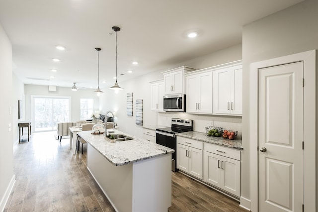 1144 Lock 4 Rd Unit B-4, Gallatin, TN 37066 - kitchen with appliances with stainless steel finishes, backsplash, a kitchen island with sink, dark wood finished floors, and white cabinets