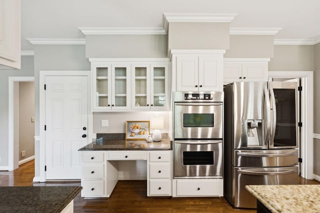 1524 Gordon Petty Dr, Brentwood, TN 37027 - kitchen featuring stainless steel appliances, ornamental molding, dark stone countertops, glass insert cabinets, and dark wood finished floors