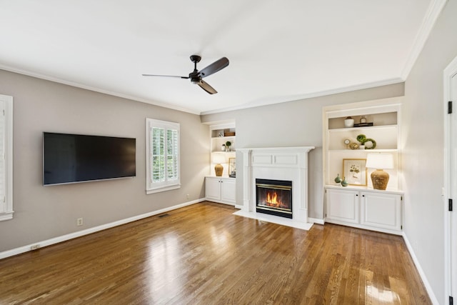 1524 Gordon Petty Dr, Brentwood, TN 37027 - unfurnished living room with wood finished floors, ornamental molding, a fireplace with flush hearth, a ceiling fan, and built in features