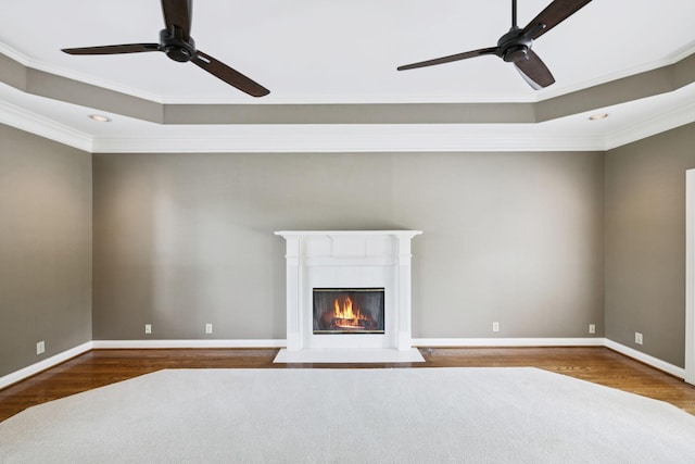 1524 Gordon Petty Dr, Brentwood, TN 37027 - unfurnished living room featuring a ceiling fan, a raised ceiling, ornamental molding, wood finished floors, and a fireplace with flush hearth