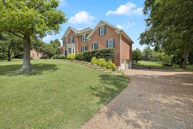 1524 Gordon Petty Dr, Brentwood, TN 37027 - view of front of property with brick siding, an attached garage, concrete driveway, and a front lawn