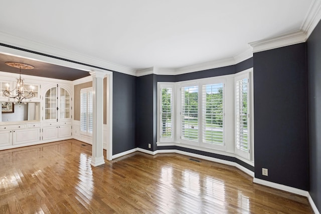 1524 Gordon Petty Dr, Brentwood, TN 37027 - empty room with wood finished floors, a chandelier, decorative columns, and ornamental molding