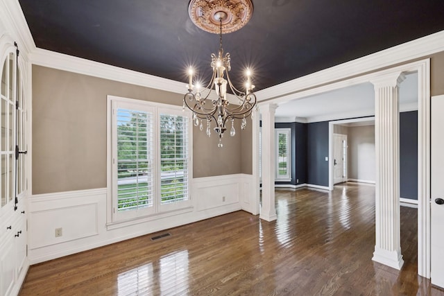 1524 Gordon Petty Dr, Brentwood, TN 37027 - unfurnished dining area with ornate columns, a chandelier, wainscoting, wood finished floors, and crown molding
