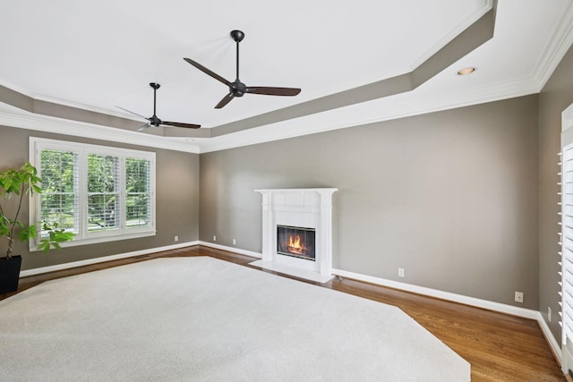 1524 Gordon Petty Dr, Brentwood, TN 37027 - unfurnished living room featuring ornamental molding, a tray ceiling, wood finished floors, a fireplace with flush hearth, and ceiling fan