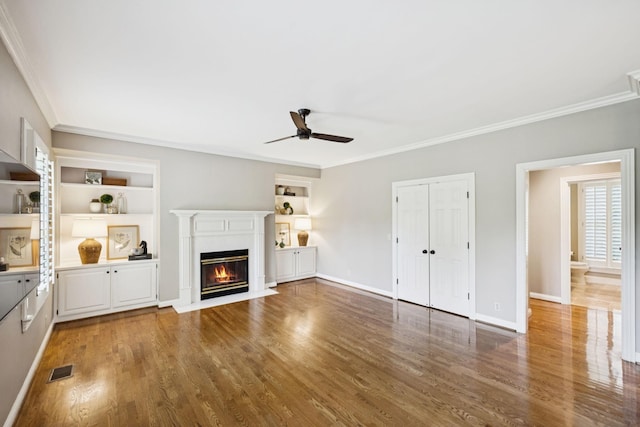 1524 Gordon Petty Dr, Brentwood, TN 37027 - unfurnished living room with ceiling fan, crown molding, built in features, wood finished floors, and a fireplace with flush hearth