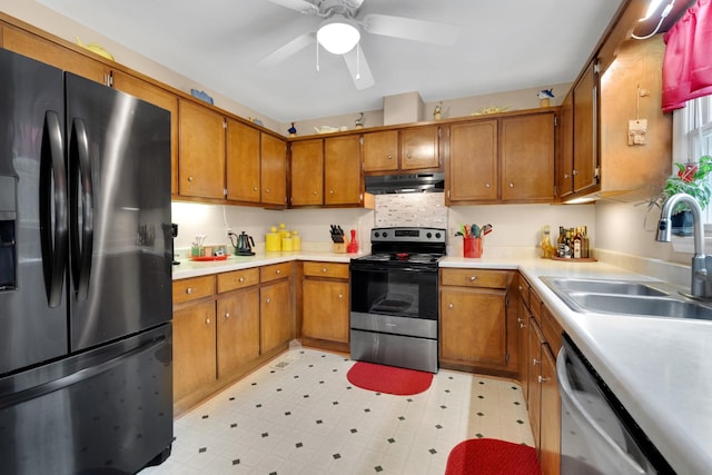 105 Plain View Dr, Estill Springs, TN 37330 - kitchen with appliances with stainless steel finishes, under cabinet range hood, brown cabinets, and light countertops