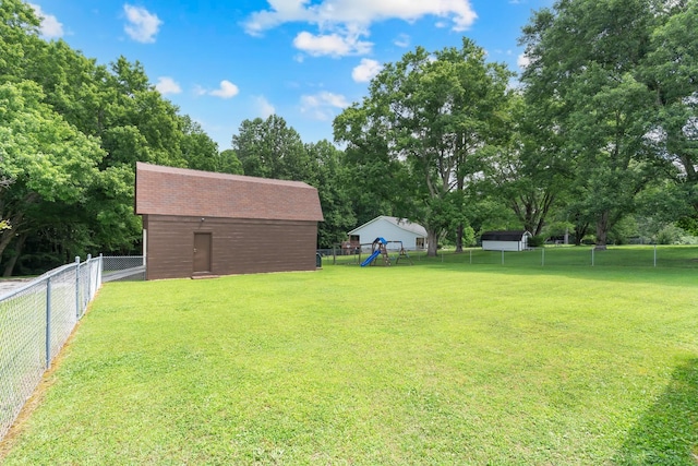 105 Plain View Dr, Estill Springs, TN 37330 - fenced backyard with a playground, view of scattered trees, and an outdoor structure