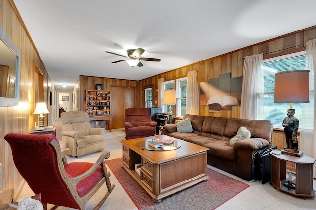 105 Plain View Dr, Estill Springs, TN 37330 - living area with wood walls, a ceiling fan, plenty of natural light, and light carpet