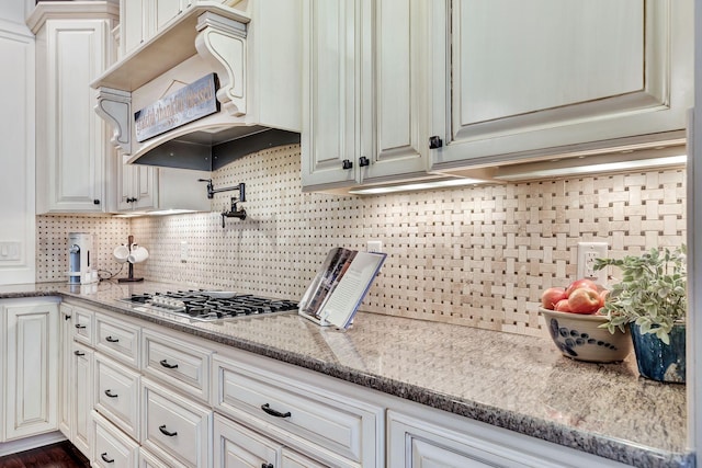 2811 Craythorne Dr, Murfreesboro, TN 37129 - kitchen featuring stainless steel gas stovetop, decorative backsplash, and light stone counters