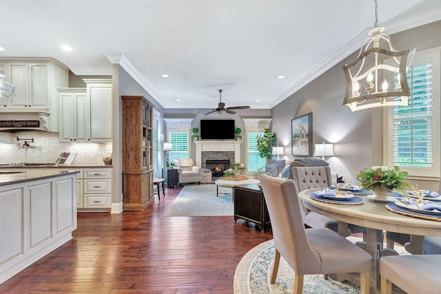 2811 Craythorne Dr, Murfreesboro, TN 37129 - dining space featuring dark wood finished floors, ceiling fan, a warm lit fireplace, a chandelier, and recessed lighting
