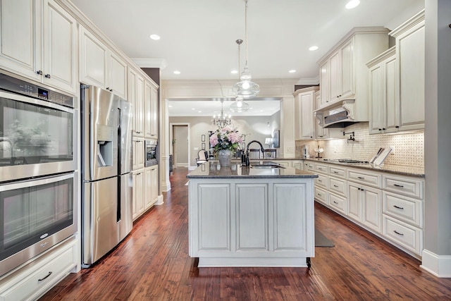 2811 Craythorne Dr, Murfreesboro, TN 37129 - kitchen with appliances with stainless steel finishes, dark stone counters, tasteful backsplash, custom exhaust hood, and crown molding