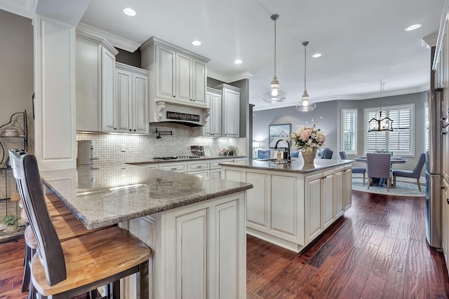 2811 Craythorne Dr, Murfreesboro, TN 37129 - kitchen with crown molding, under cabinet range hood, dark wood-type flooring, decorative backsplash, and a peninsula