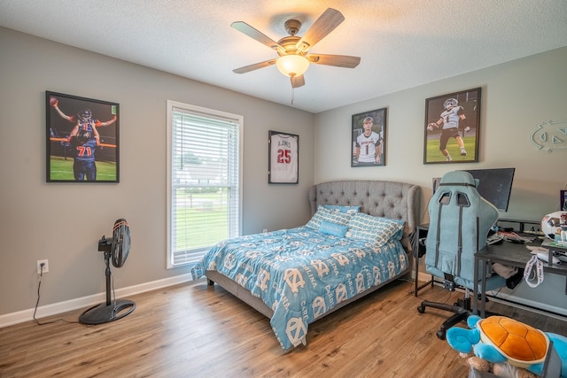 545 Kent St, Lawrenceburg, TN 38464 - bedroom with wood finished floors, ceiling fan, and a textured ceiling